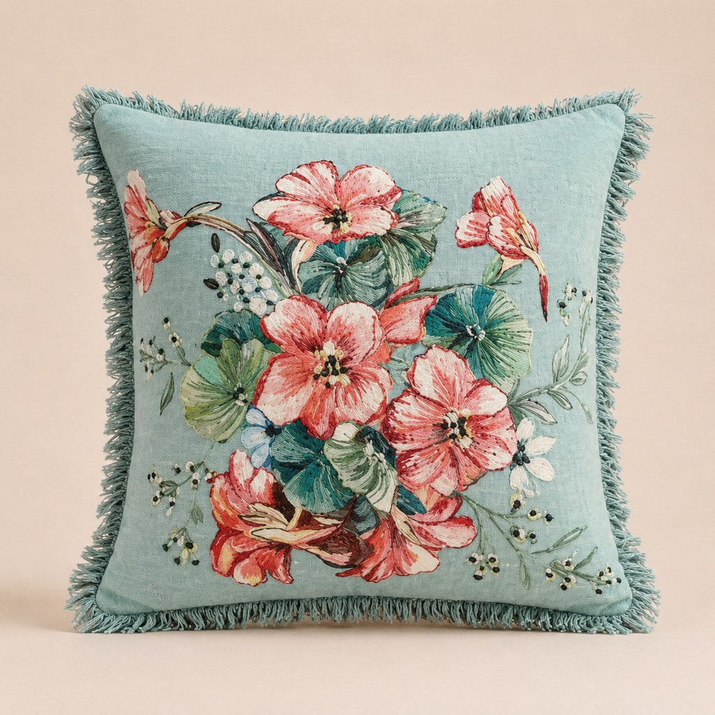Aqua Bloom cushion in pale aqua linen with a brush-fringe edge, coral and rose blooms