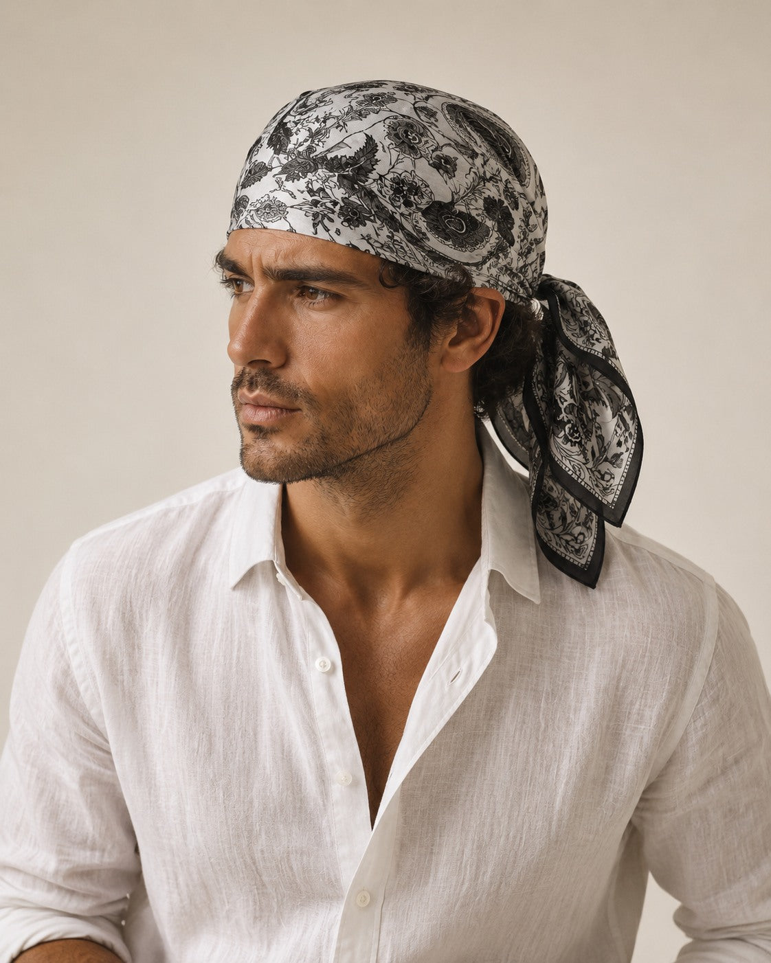 Male model wearing the Noir Paisley silk bandana tied on the head
