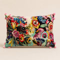 Wildflower Riot Cushion — multicoloured embroidered flowers on velvet with pink pom-pom trim