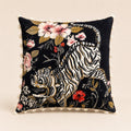 Golden Tiger Cushion — gold-embroidered tiger among blossoms on black velvet with tassel trim