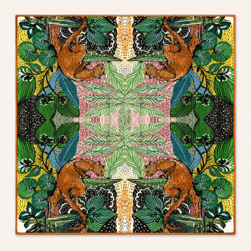 Jungle Caracal silk scarf, 40x40 — mirrored jungle cats and foliage with burnt-orange border, satin flat lay