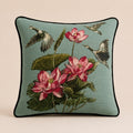 Lotus Heron cushion in sea-green linen with black piping, herons flying above lotus flowers