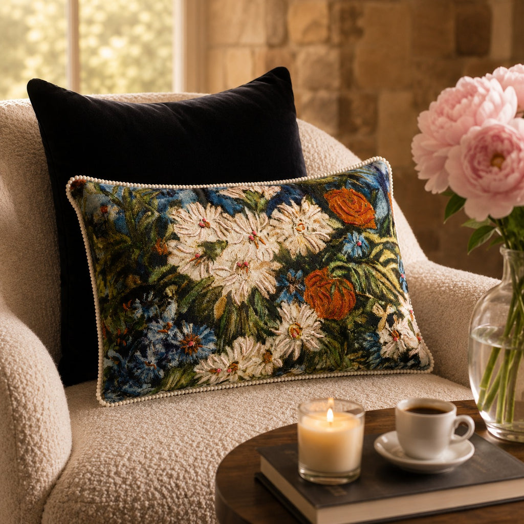 Meadow Daisy Cushion styled on a cream armchair beside pink peonies