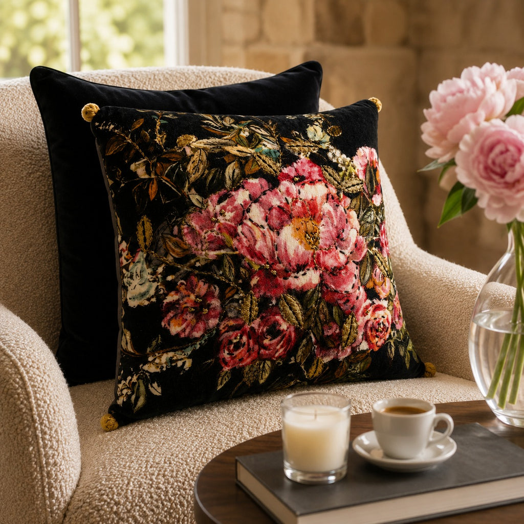 Midnight Rose Cushion styled on a cream armchair beside pink peonies