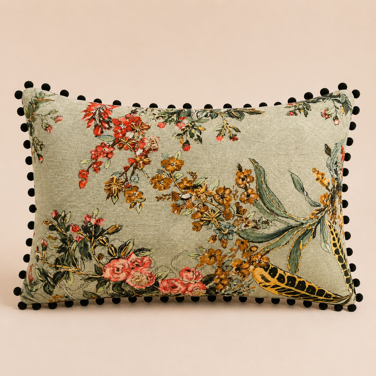 Pheasant Feather cushion — ochre blossom and barred feathers on sage with black pom-pom trim, flat catalogue