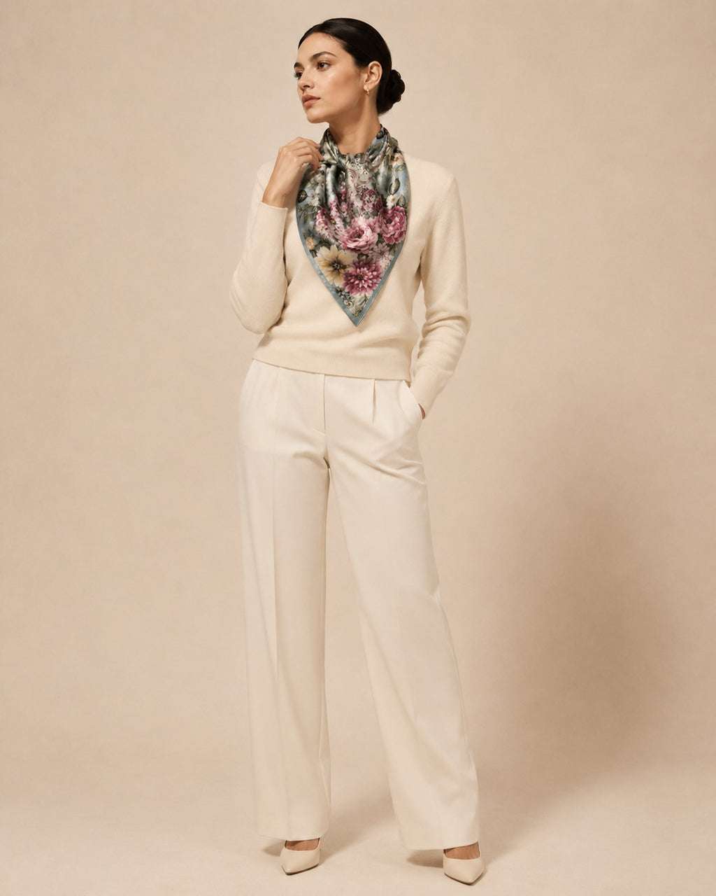 Model wearing the Rose Garland diamond silk scarf knotted at the neck with cream knitwear