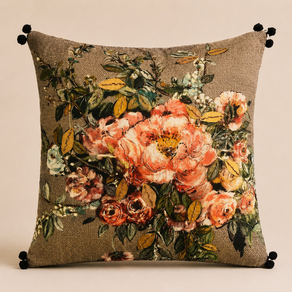 Tweed Rose cushion — peach and coral roses on a bronze tweed ground with black pom-poms, flat catalogue