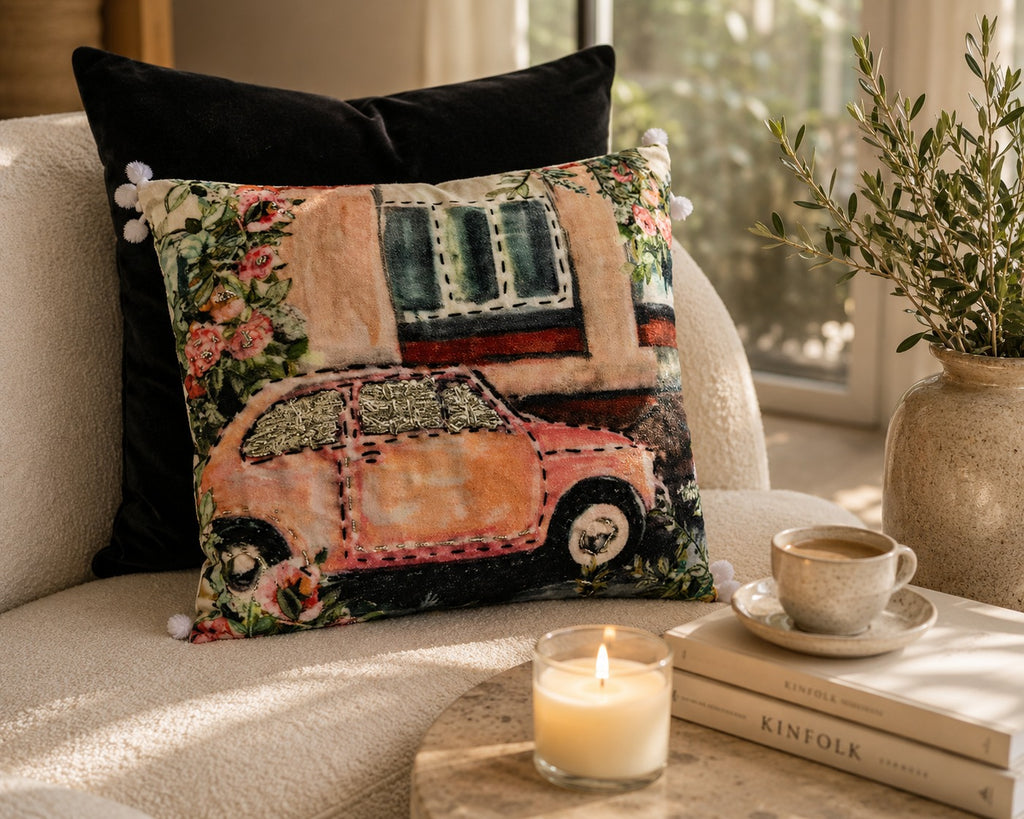 Vintage Motor cushion styled on a cream armchair with a candle and coffee cup