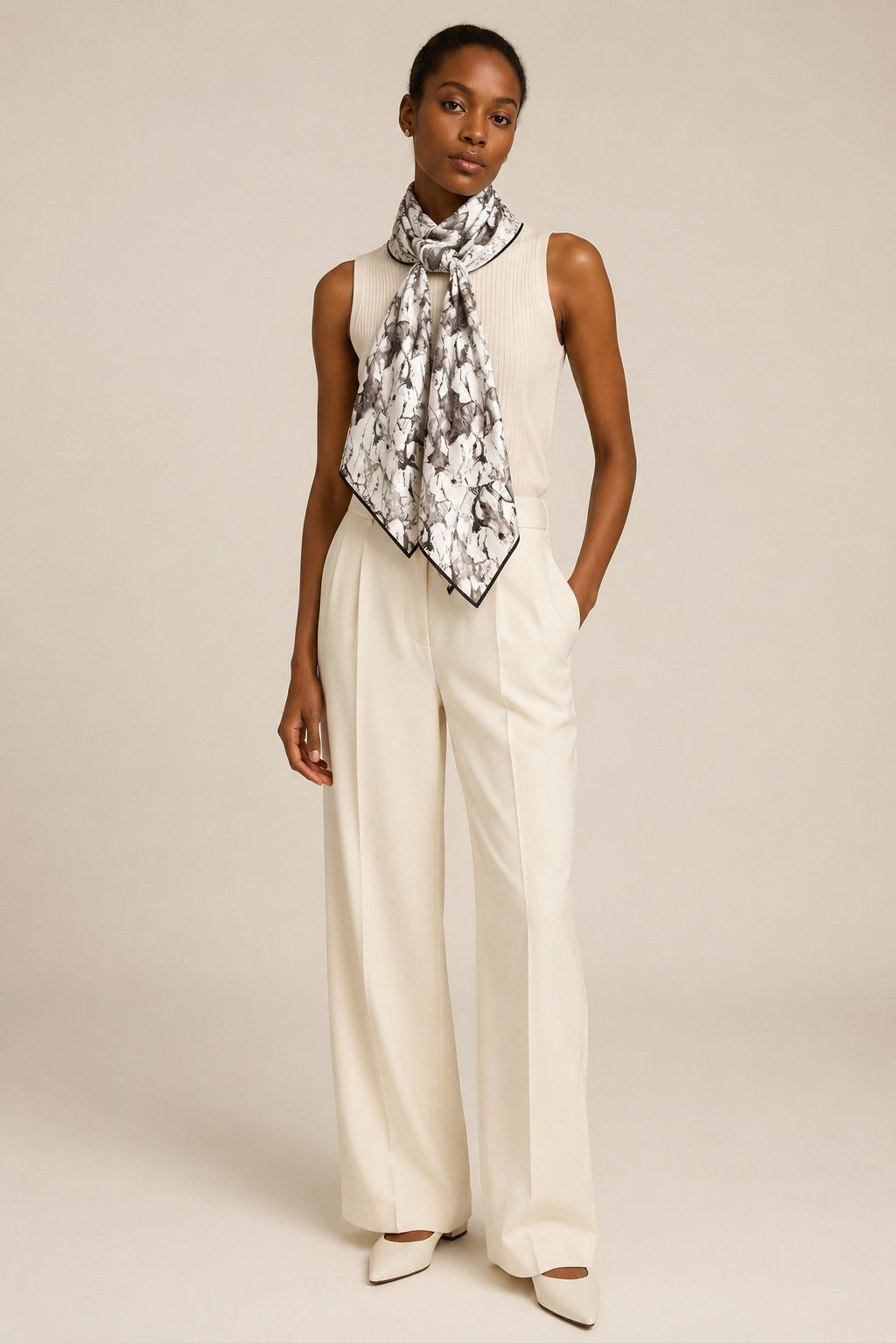 Model wearing the Wild Horses silk scarf tied at the neck with cream tailoring